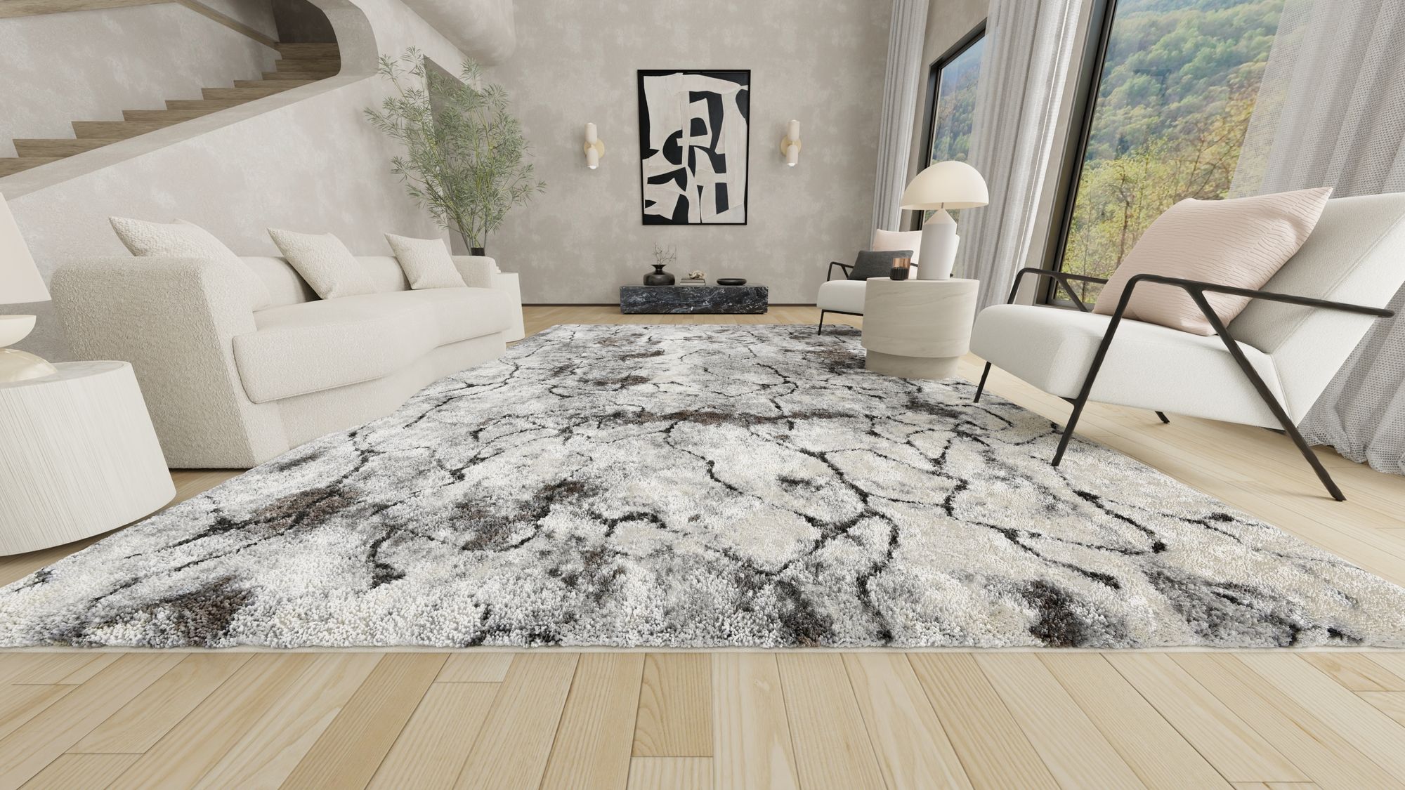 Contemporary living room with a luxurious white and black abstract Opal rug, white furniture, modern art, and large windows with a scenic view.