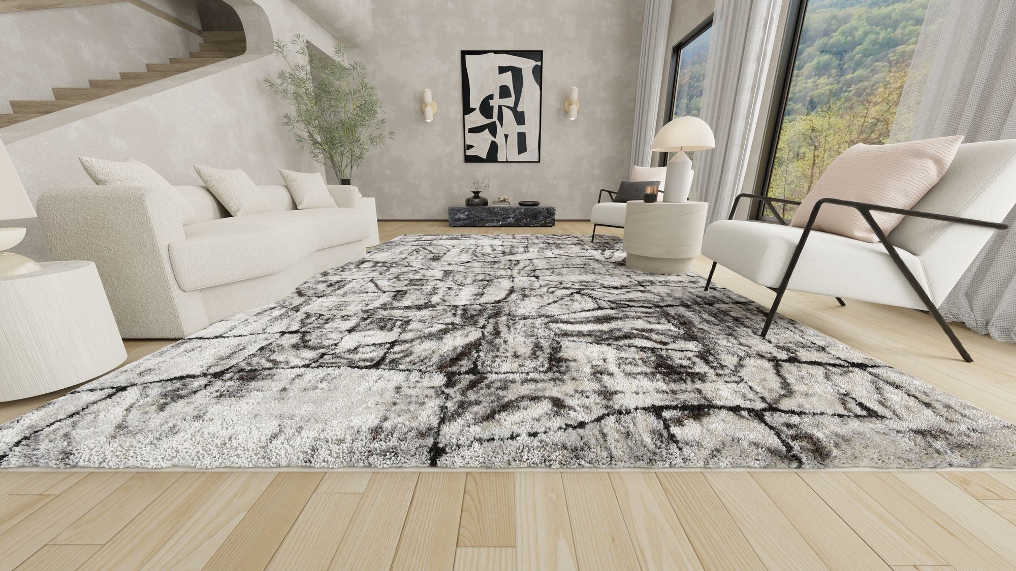 Luxurious white and black abstract Opal rug in a contemporary living room with white furniture, modern art, and large windows offering a scenic view.